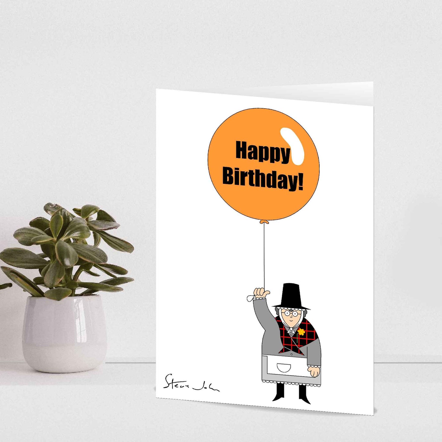 Welsh lady holding birthday balloon card